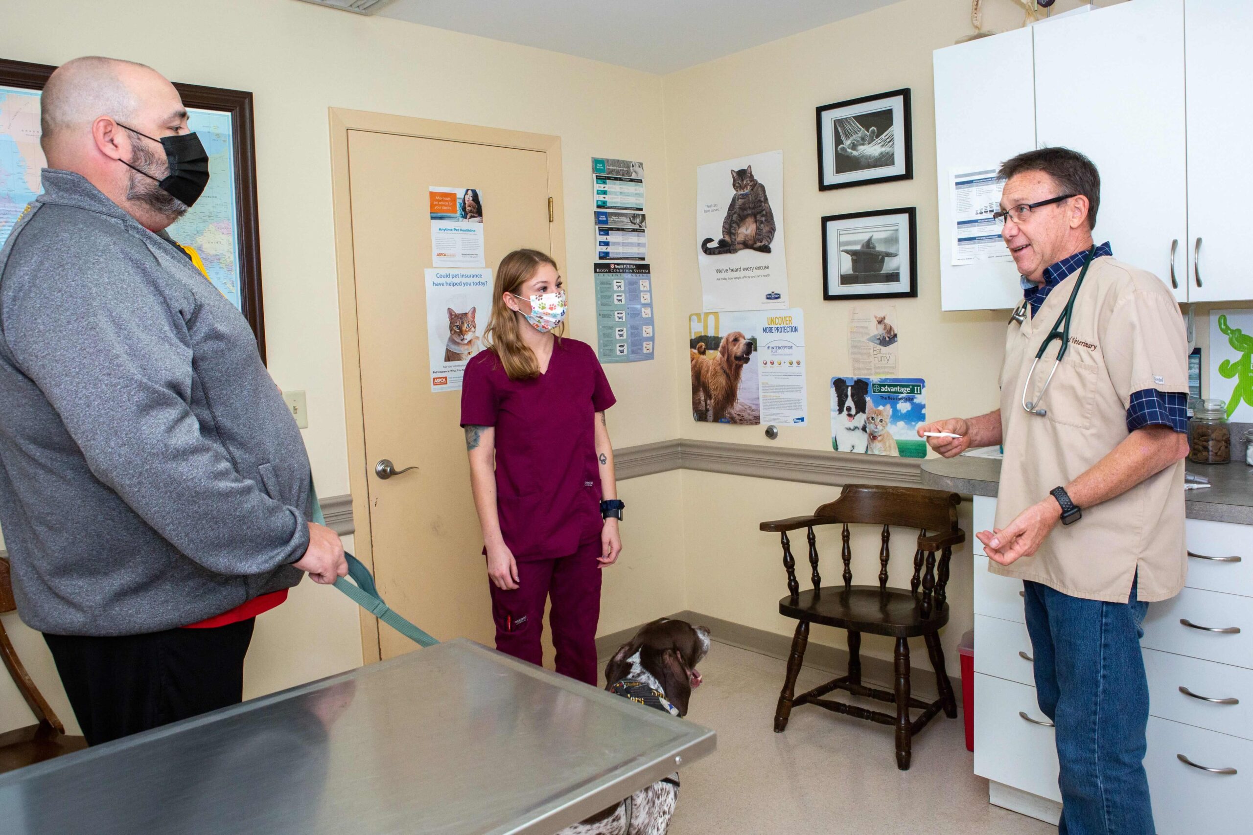 dog owner, Dr. fritz mcHugh and staff in the clinic